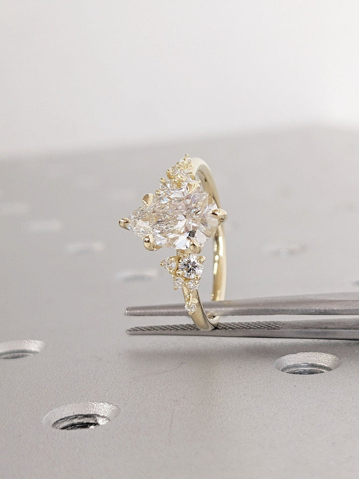 Top-down view of pear cut cluster engagement ring