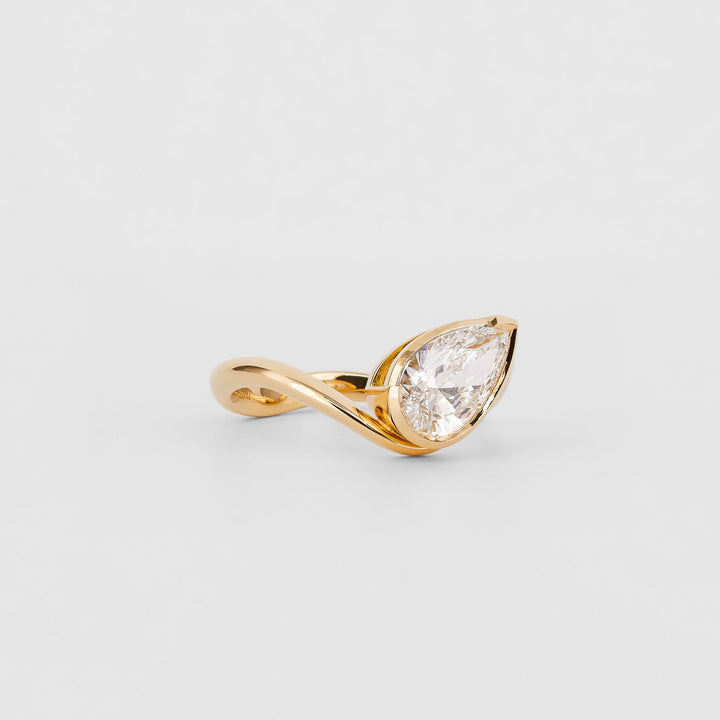 Pear solitaire engagement ring photographed in natural light