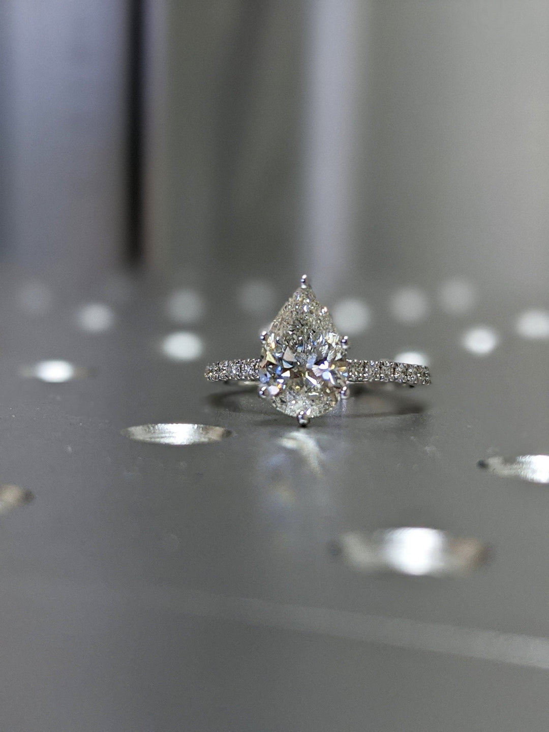 Pear pave engagement ring shown on hand for true-to-life sizing