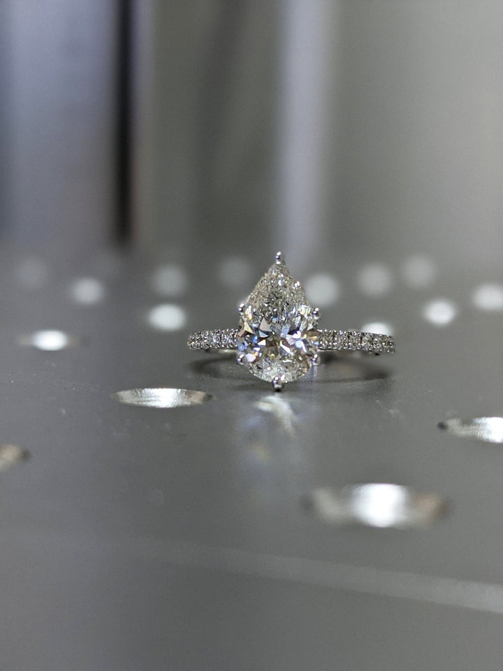 Pear pave engagement ring shown on hand for true-to-life sizing