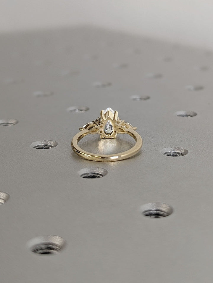 Pear cut diamond ring worn on hand