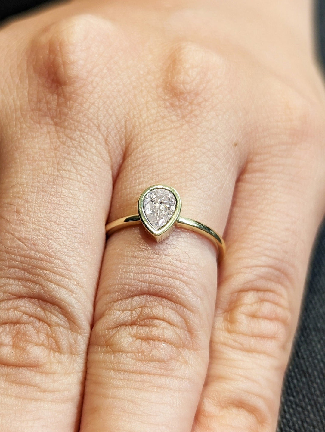 Fine craftsmanship detail on pear bezel engagement ring