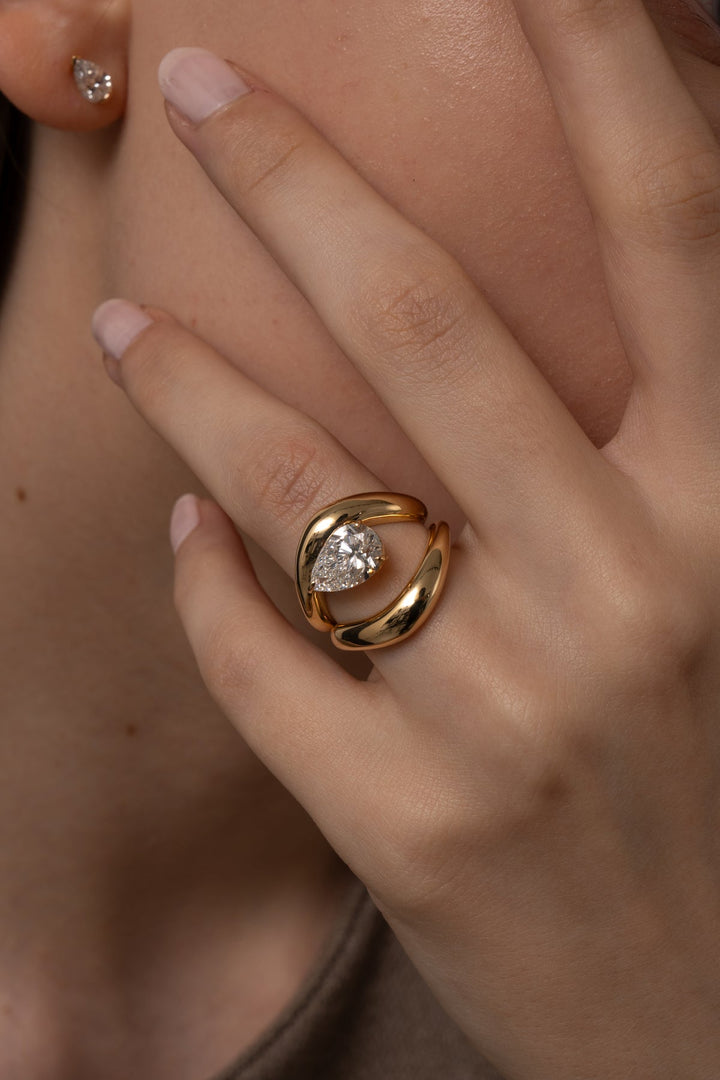 Pear dome diamond engagement ring available in multiple metals