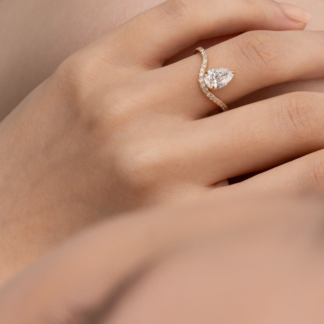 Close-up of pear cut center diamond in solitaire engagement ring