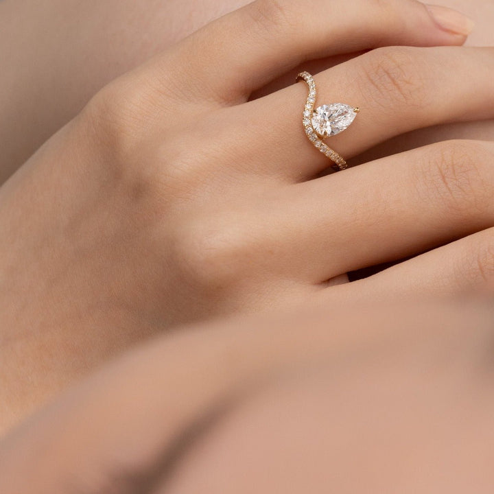 Close-up of pear cut center diamond in solitaire engagement ring