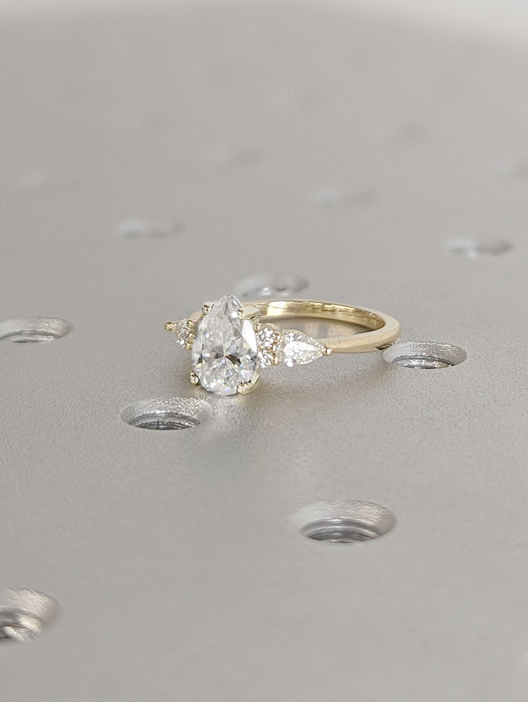 Pear cluster engagement ring viewed from the side