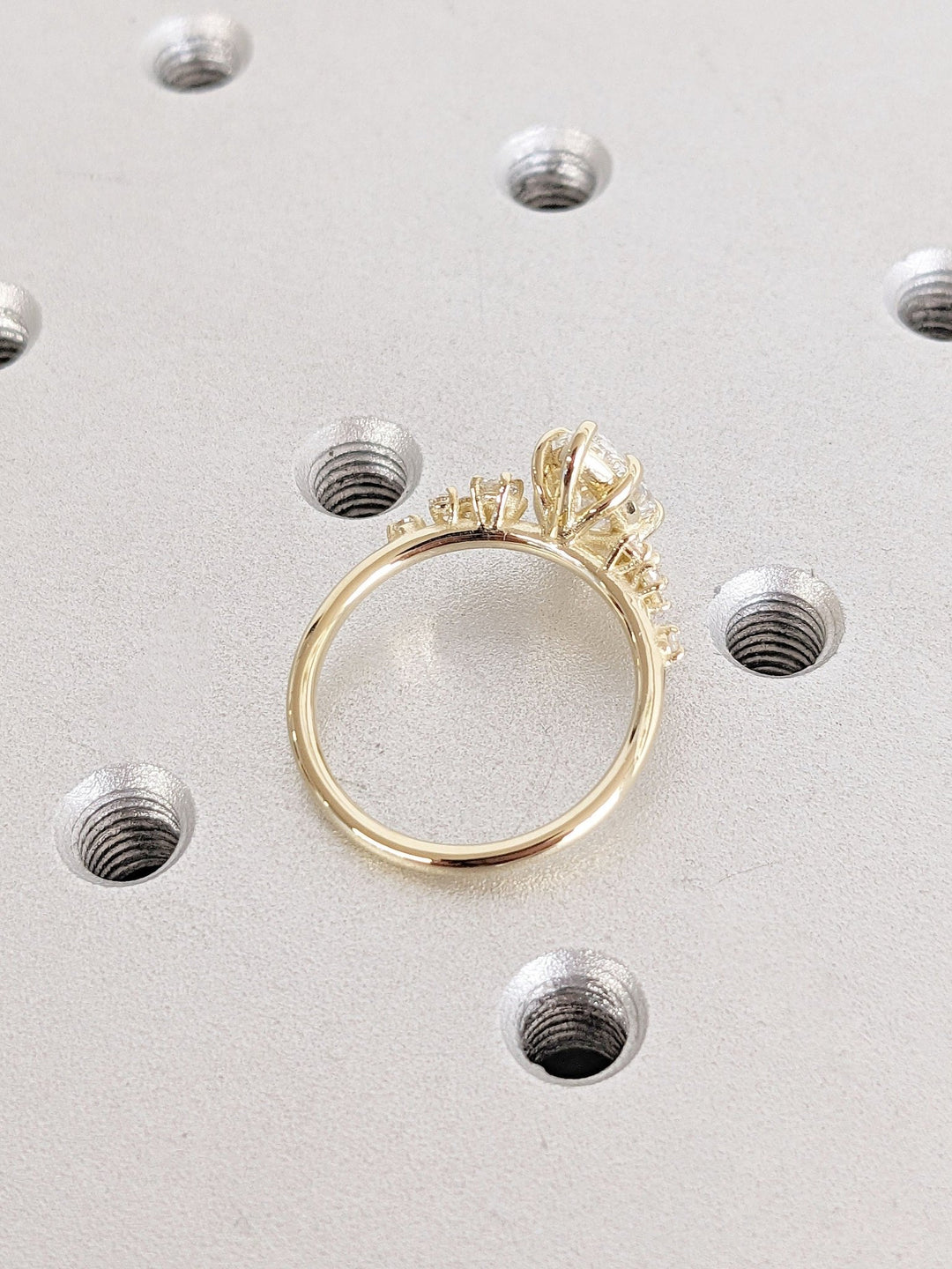 Fine craftsmanship detail on pear cluster engagement ring