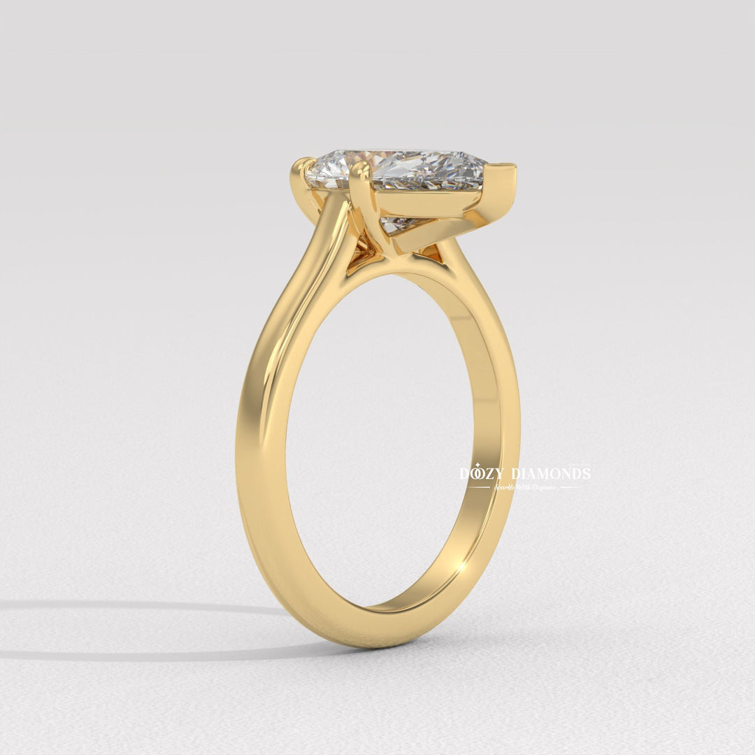 Pear solitaire engagement ring finished in polished solid gold
