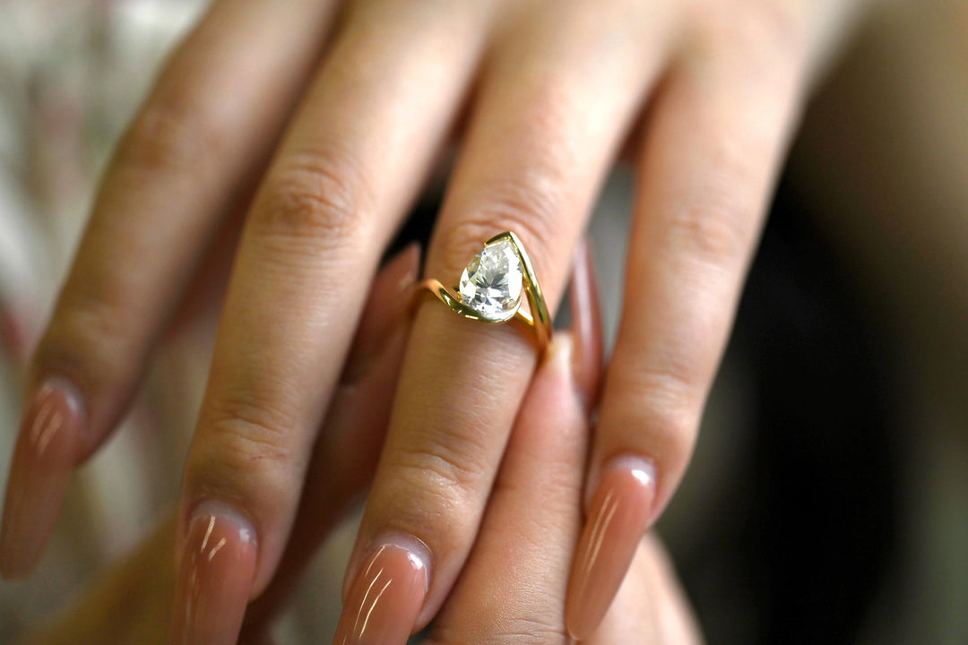 Pear cut diamond ring worn on hand