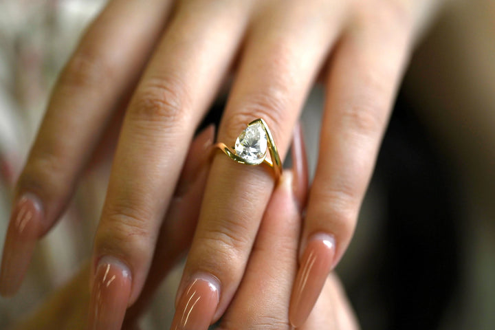 Pear cut diamond ring worn on hand