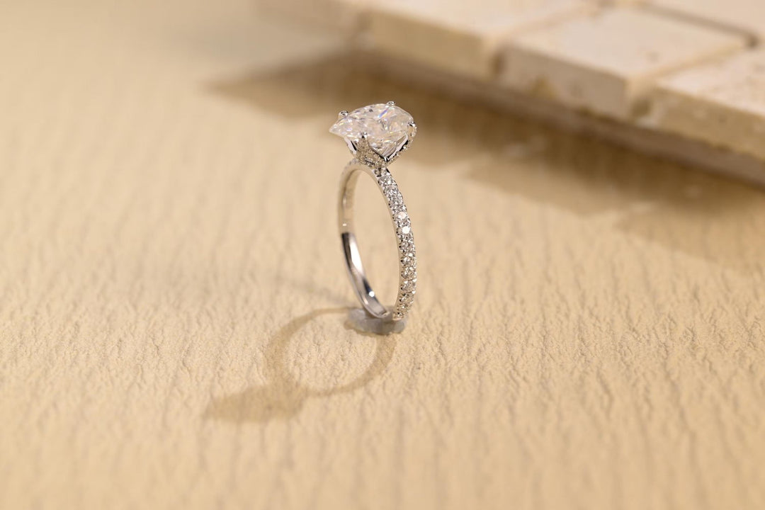 Close-up of pear cut center diamond in hidden halo engagement ring