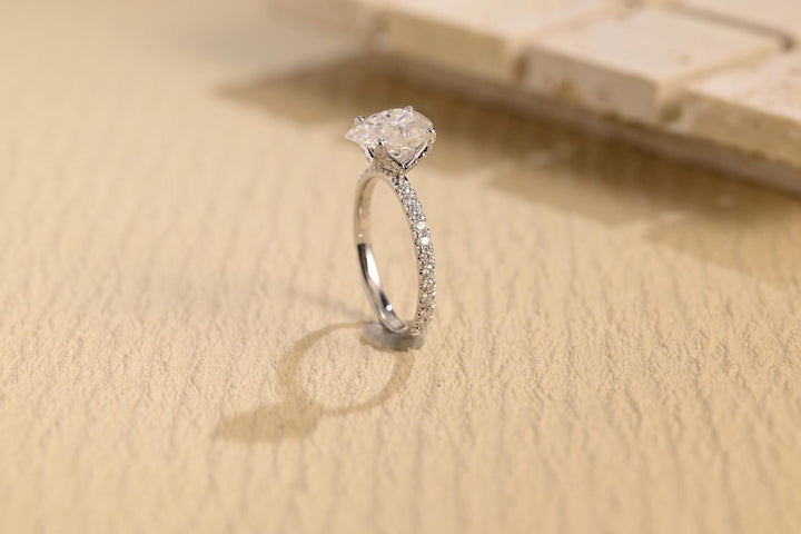 Close-up of pear cut center diamond in hidden halo engagement ring