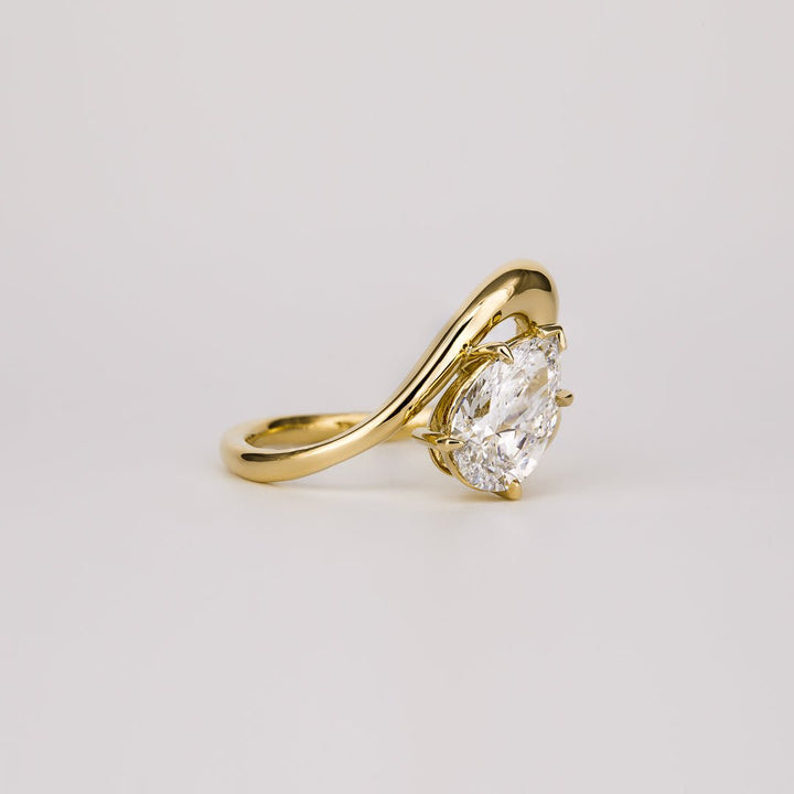 Pear solitaire engagement ring close-up highlighting diamond sparkle