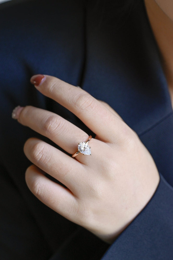 Fine craftsmanship detail on pear hidden halo engagement ring