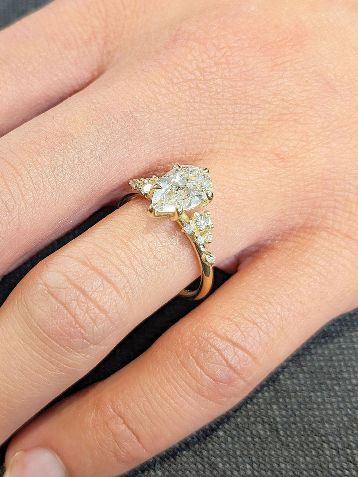 Pear cluster engagement ring photographed in natural light