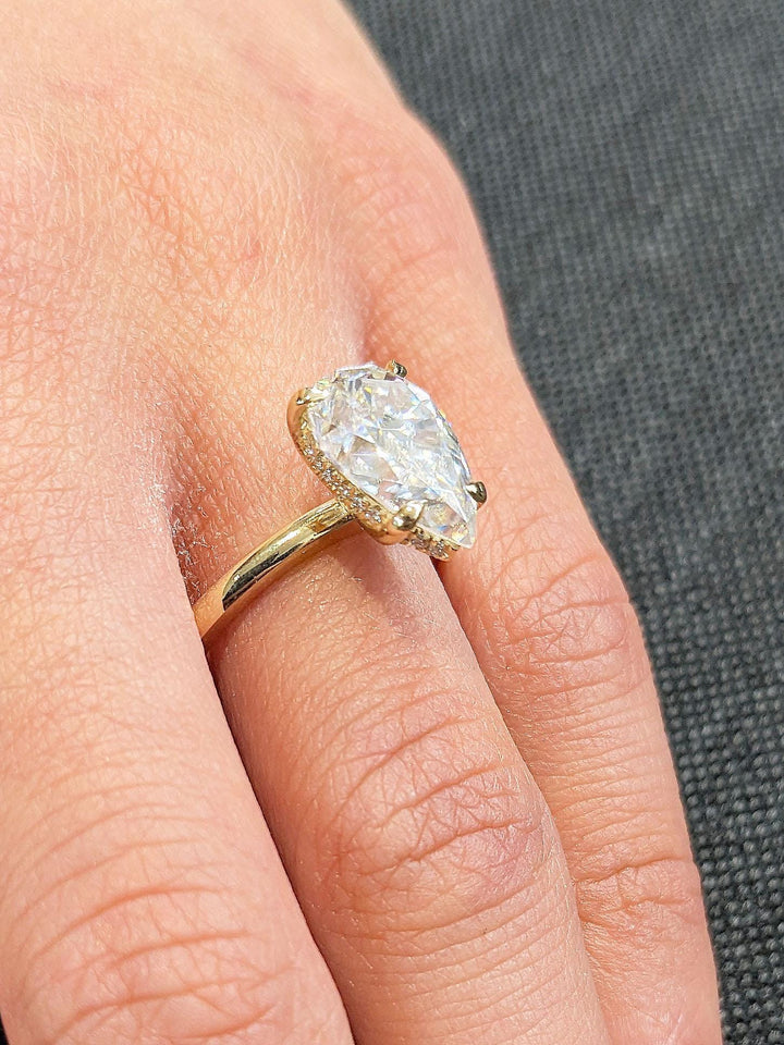 Pear hidden halo diamond engagement ring available in multiple metals
