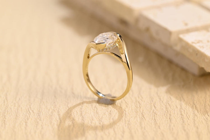 Pear solitaire engagement ring shown on hand for true-to-life sizing