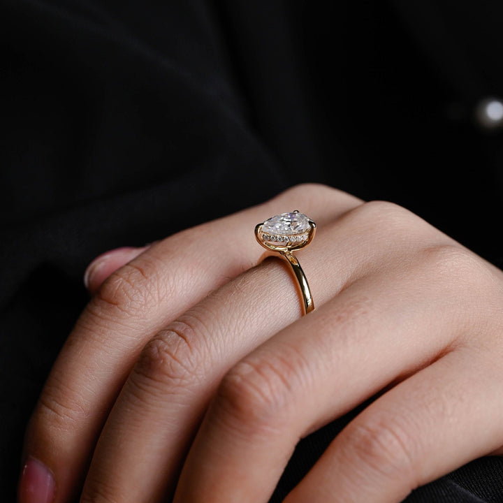 Pear hidden halo engagement ring close-up showing high clarity diamond clarity
