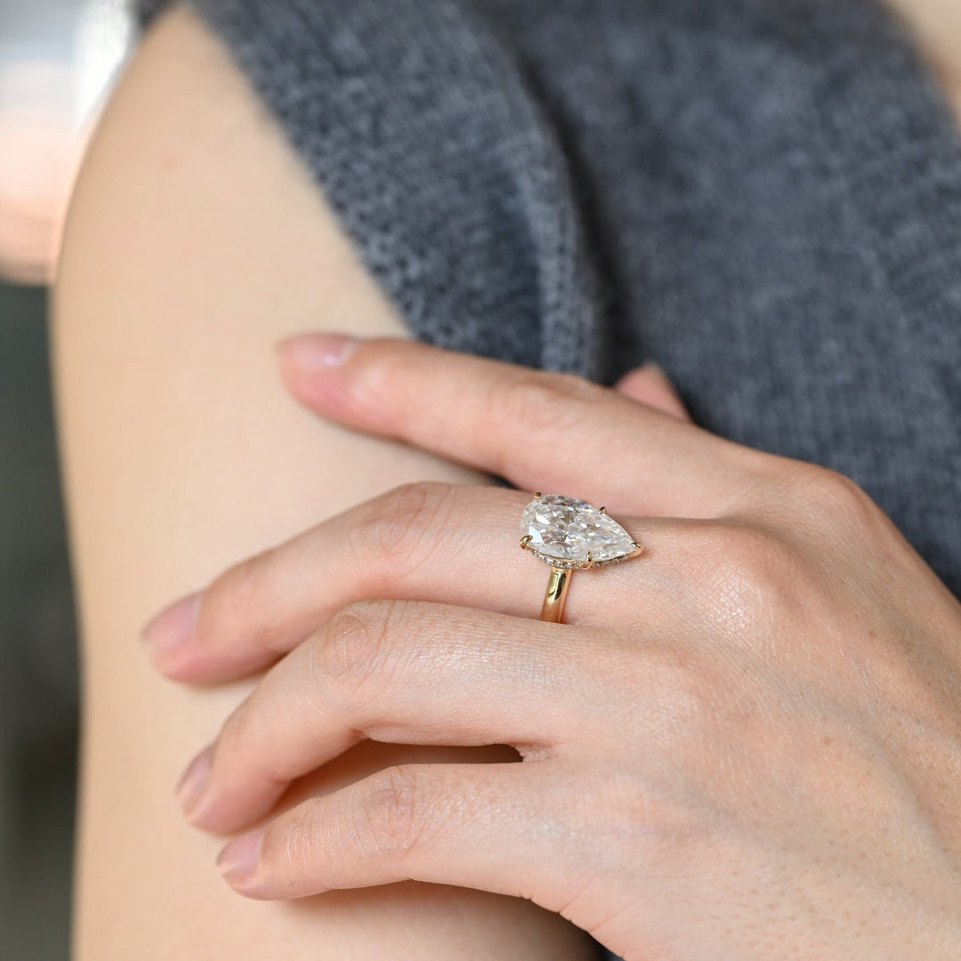 Pear cut diamond ring worn on hand