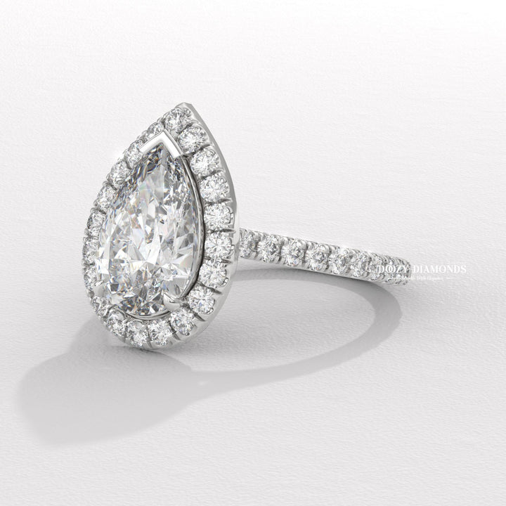 Pear halo engagement ring viewed from the side