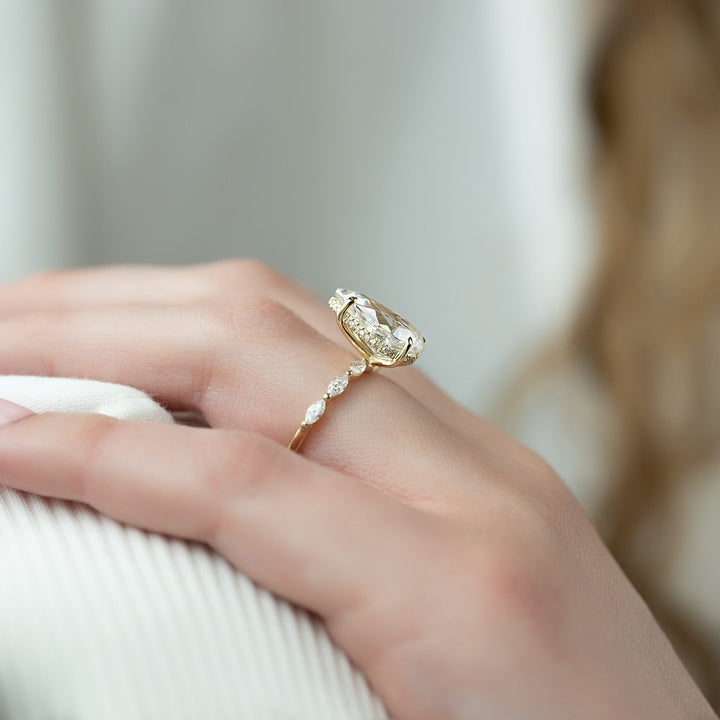 Pear cut engagement ring shown with authenticity certificate