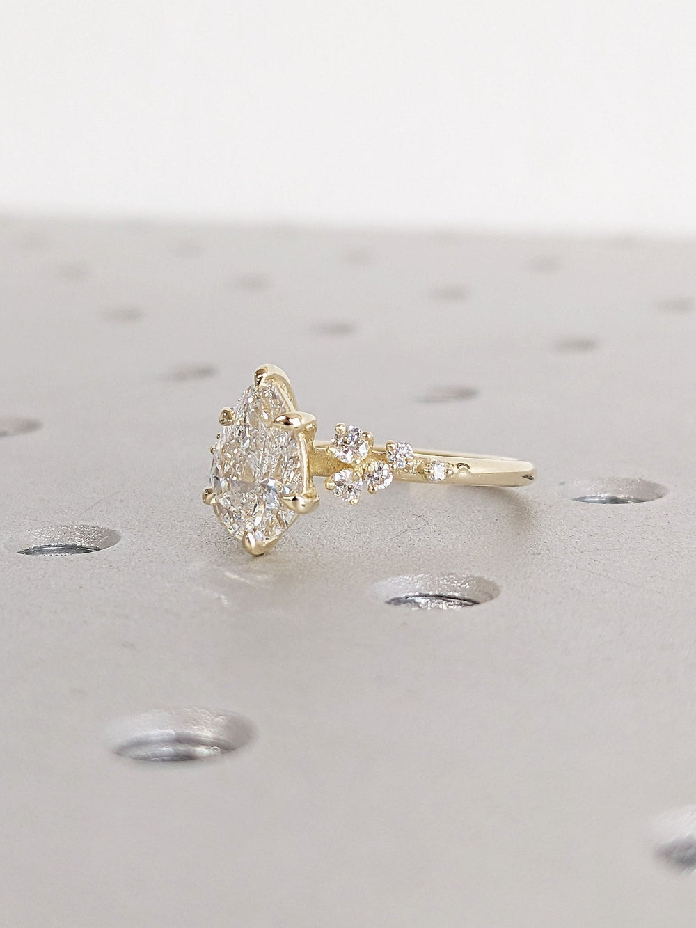 Premium pear cut cluster engagement ring crafted in solid gold