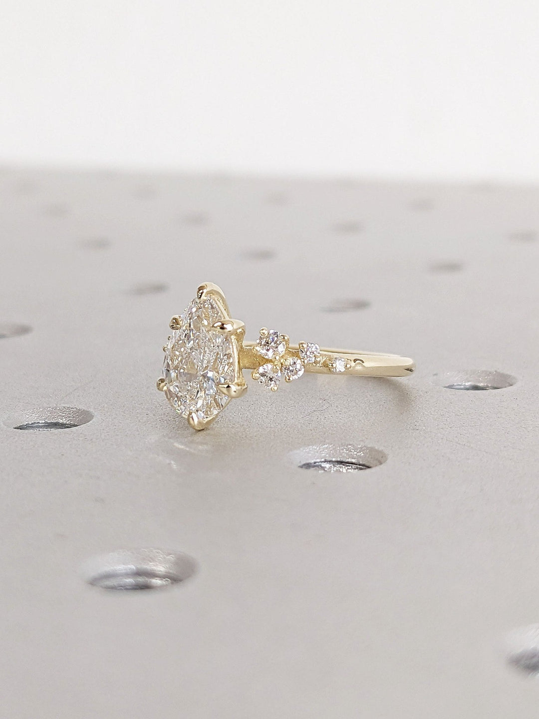 Premium pear cut cluster engagement ring crafted in solid gold