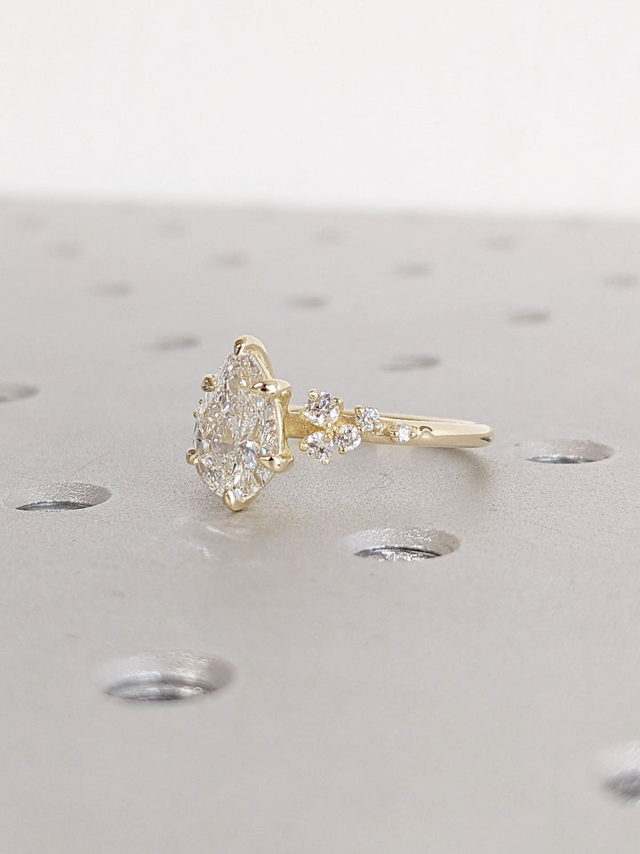 Premium pear cut cluster engagement ring crafted in solid gold