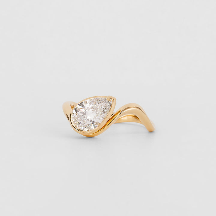 Pear solitaire engagement ring finished in polished solid gold