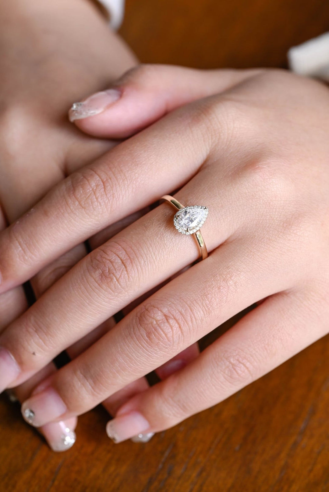 Top-down view of pear cut halo engagement ring