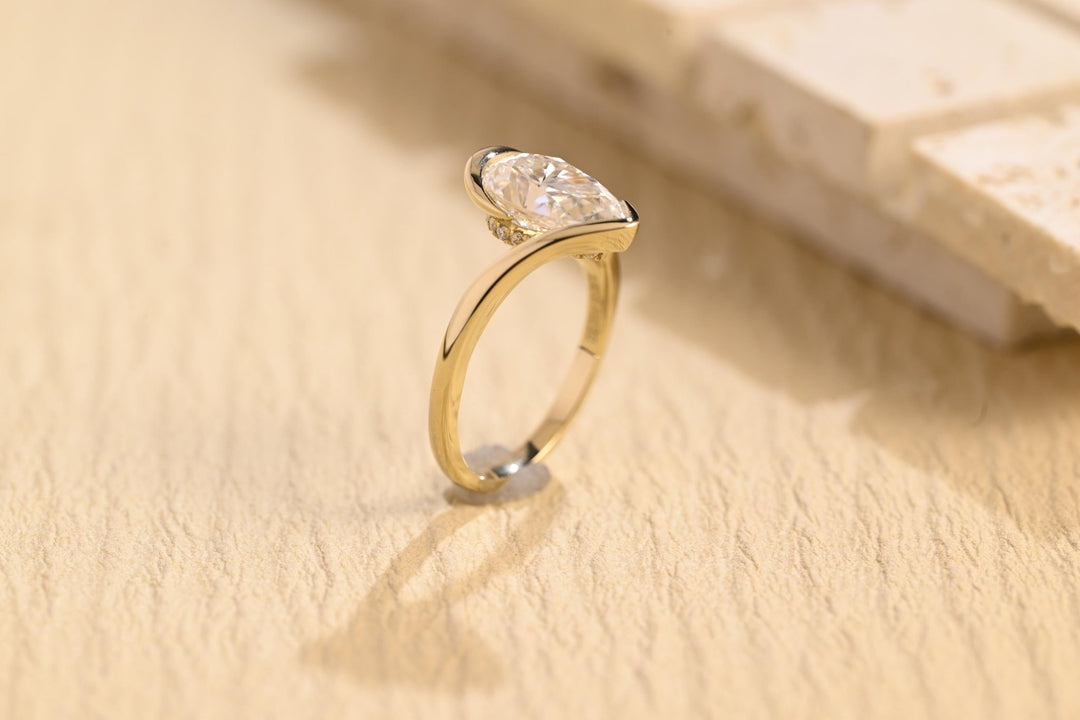 Pear solitaire engagement ring viewed from the side