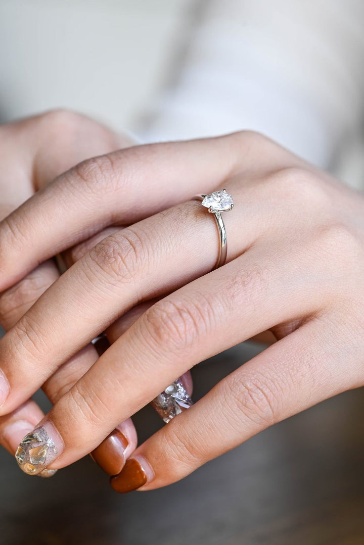 Pear solitaire engagement ring photographed in natural light