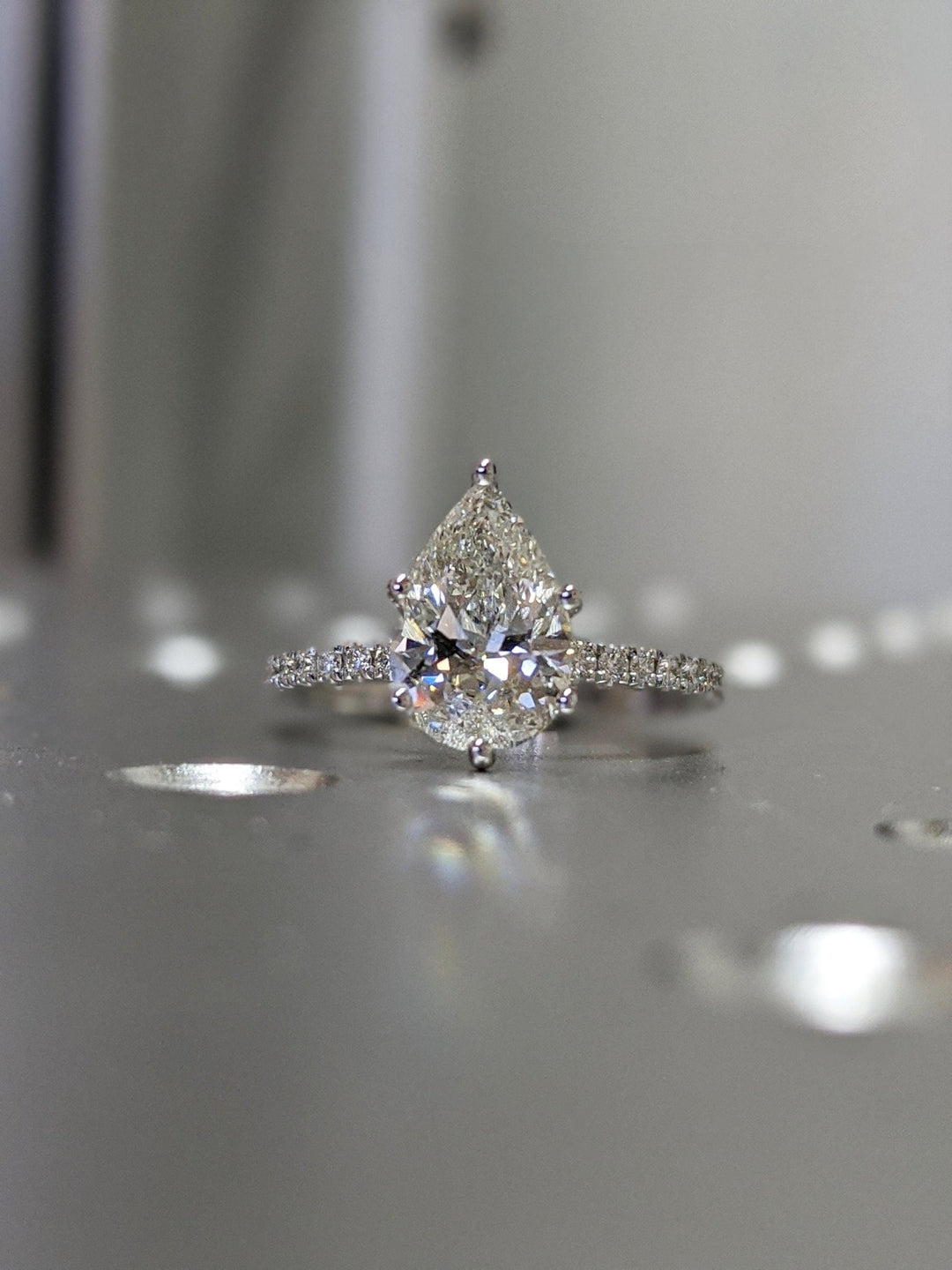 Lifestyle shot of pear pave diamond ring on hand