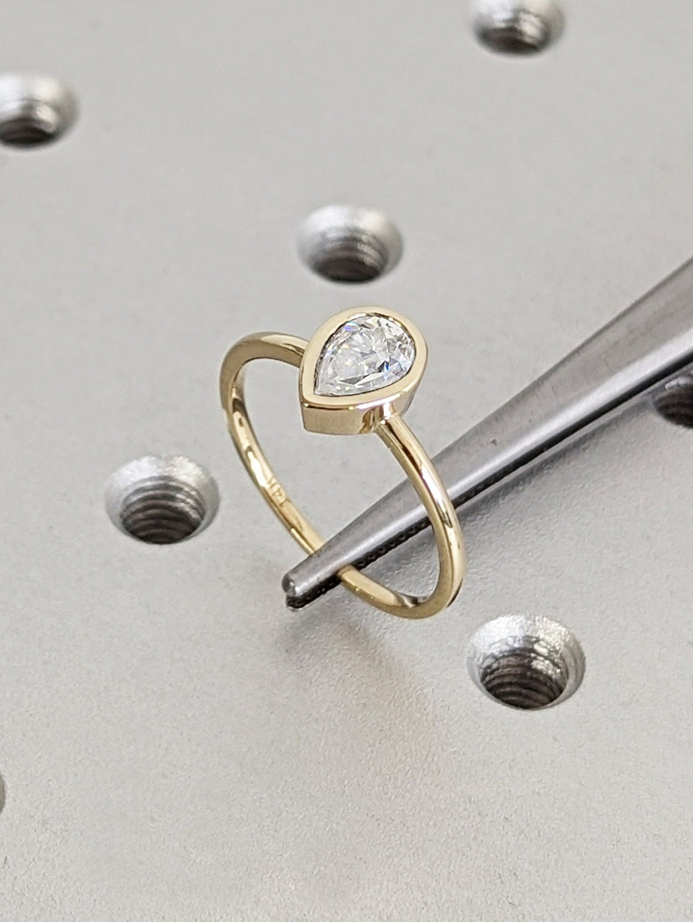 Handcrafted pear cut bezel lab grown diamond engagement ring