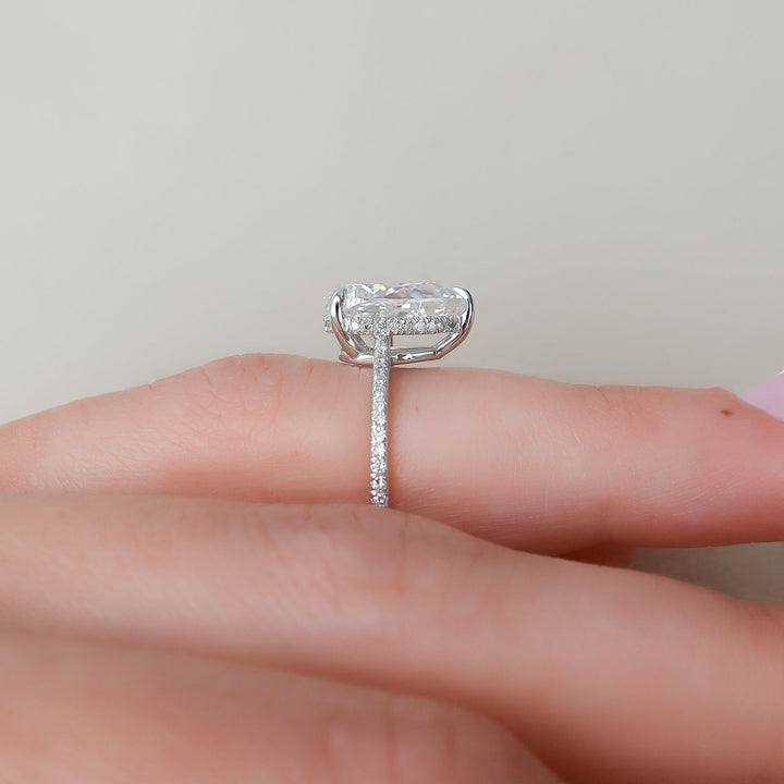 Pear hidden halo diamond ring displayed on jewelry stand