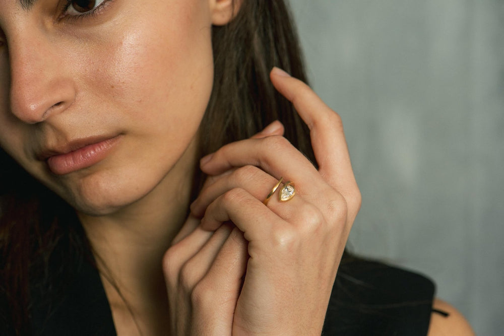Pear solitaire lab grown diamond ring fitted on finger