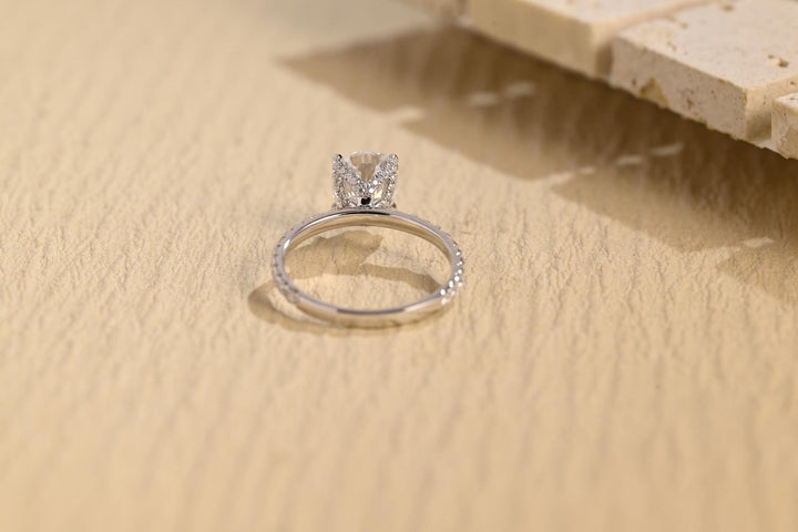 Pear hidden halo engagement ring close-up highlighting diamond sparkle