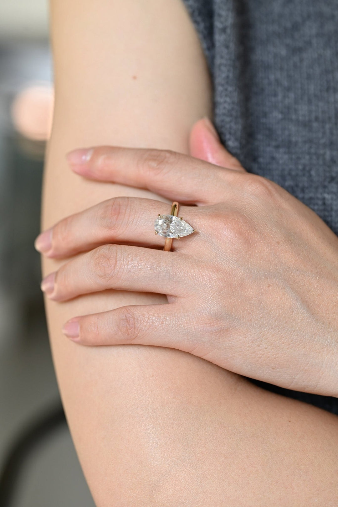 Pear hidden halo engagement ring viewed from the side