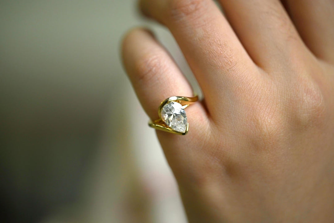 Pear solitaire lab grown diamond ring fitted on finger