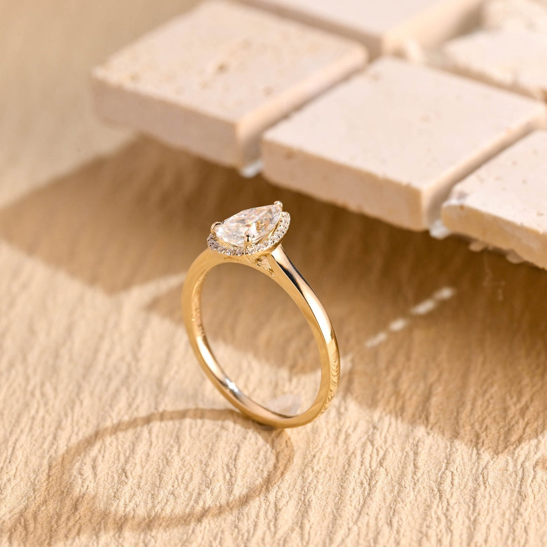 Pear halo engagement ring photographed in natural light