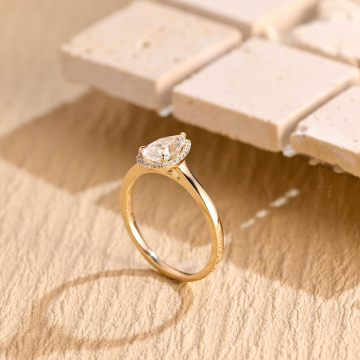 Pear halo engagement ring photographed in natural light