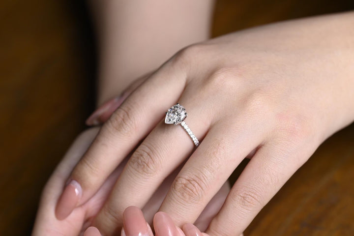 Macro shot of pear cut diamond facets in hidden halo ring setting