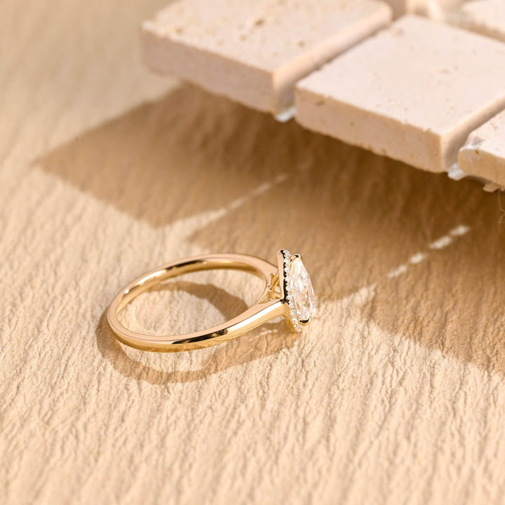 Premium pear cut halo engagement ring crafted in solid gold