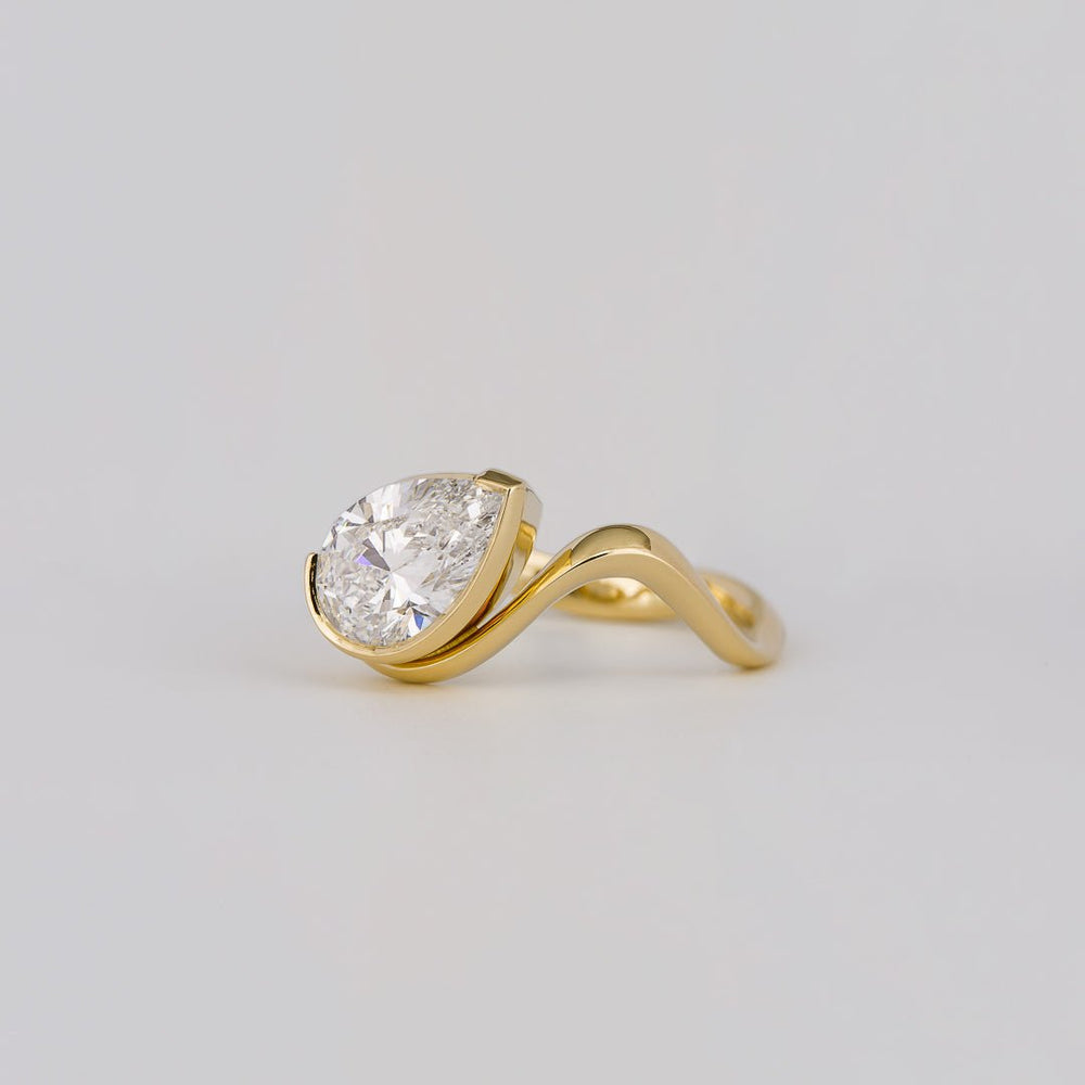 Pear cut solitaire engagement ring with IGI certified center diamond