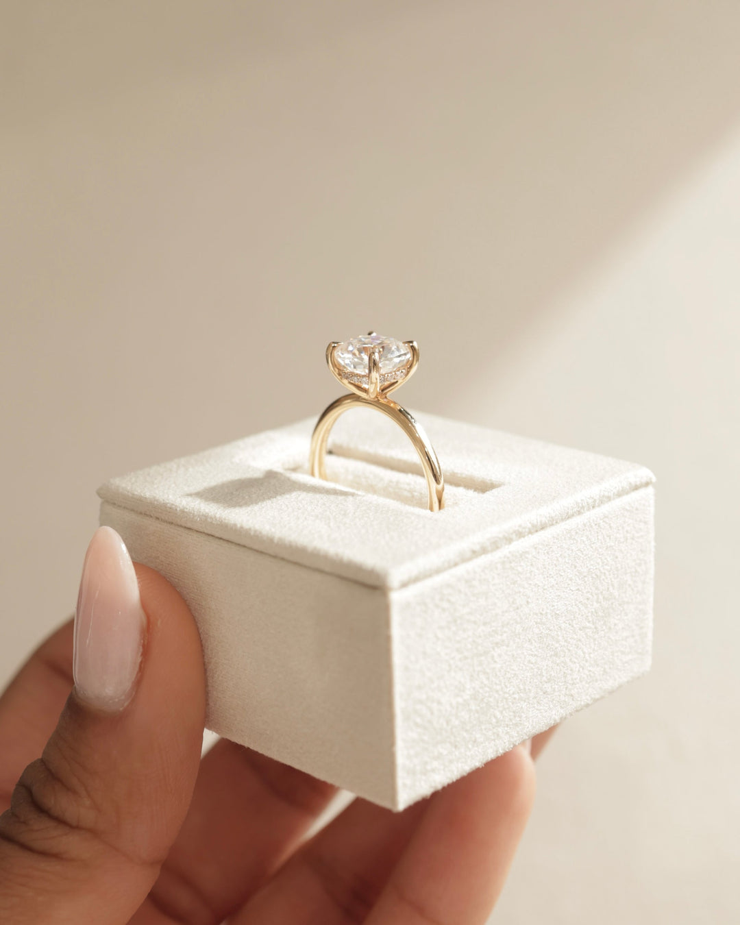 Cushion hidden halo engagement ring close-up highlighting diamond sparkle