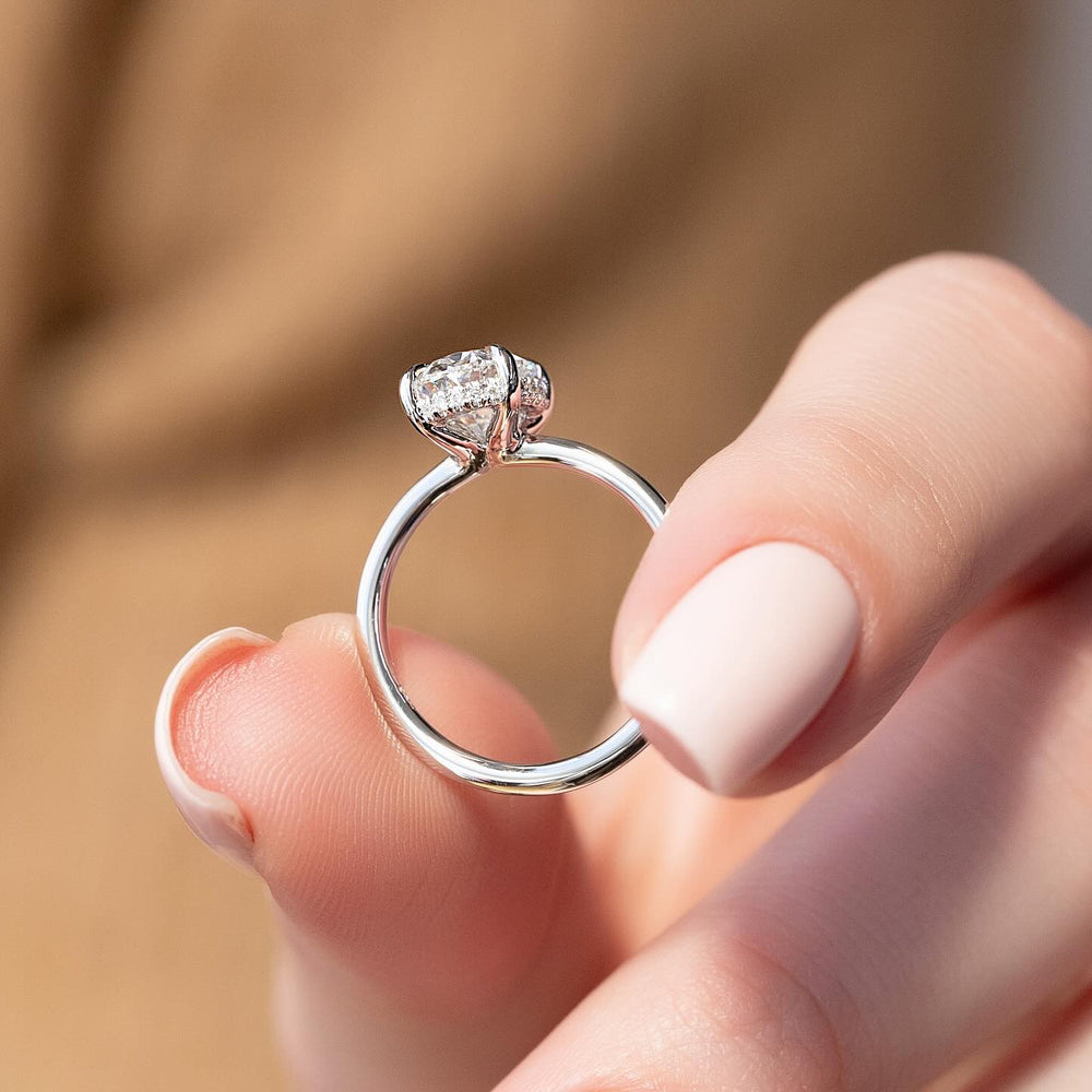 Oval hidden halo diamond engagement ring available in multiple metals