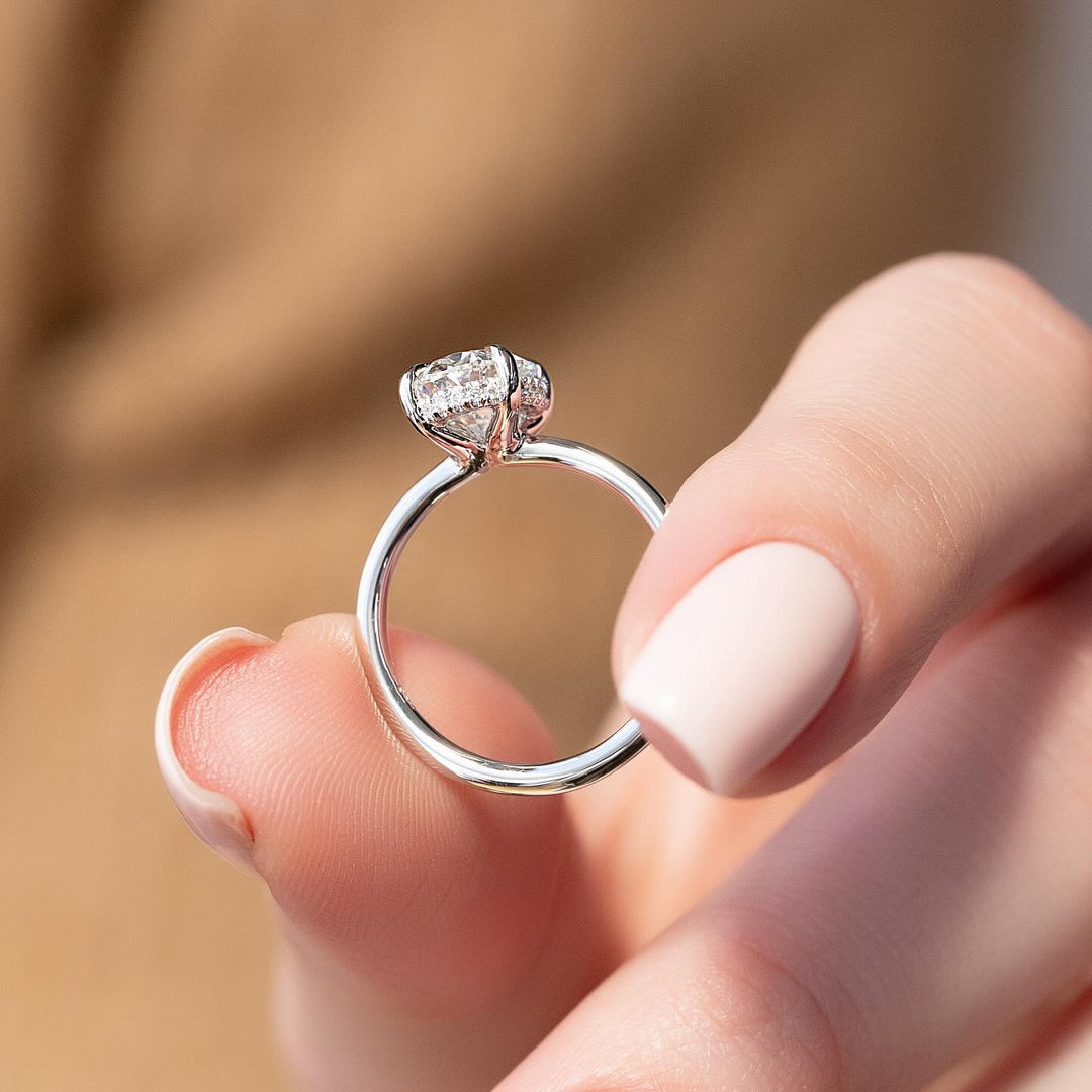Oval hidden halo diamond engagement ring available in multiple metals