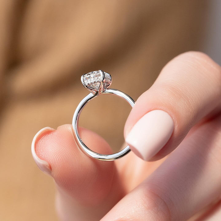 Oval hidden halo diamond engagement ring available in multiple metals