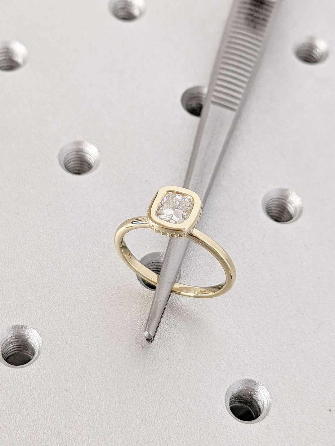 Angled view of cushion cut diamond in hidden halo setting