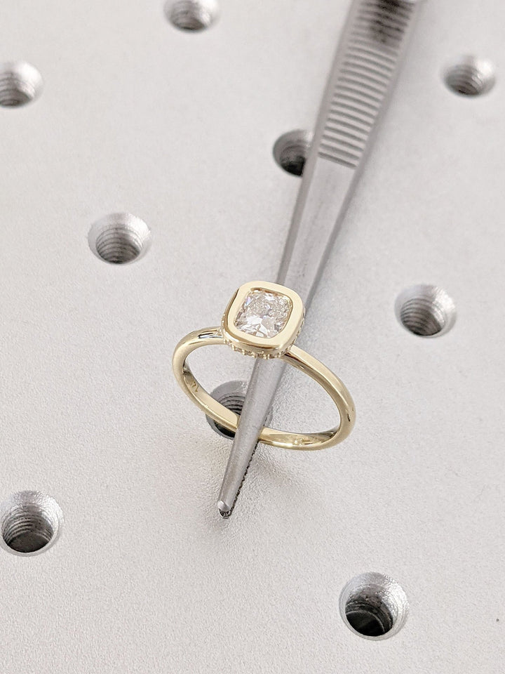 Angled view of cushion cut diamond in hidden halo setting